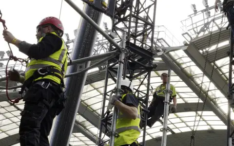 Rigging crew building outdoor concert stage